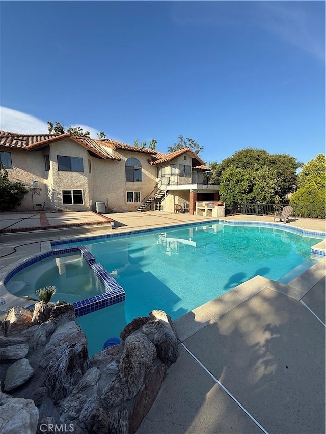 10919 Boulder Canyon Rd, Rancho Cucamonga, CA 91737 - view of pool with stairway, a patio, and a pool with connected hot tub