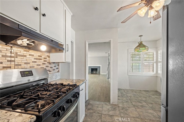 1906 Cloverdale Dr, Pomona, CA 91767 - kitchen featuring appliances with stainless steel finishes, tasteful backsplash, white cabinetry, under cabinet range hood, and light stone countertops