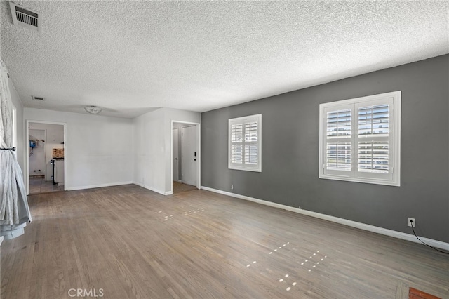 1906 Cloverdale Dr, Pomona, CA 91767 - unfurnished living room featuring a textured ceiling and wood finished floors