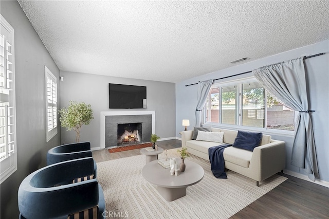 1906 Cloverdale Dr, Pomona, CA 91767 - living room featuring wood finished floors, a fireplace with flush hearth, and a textured ceiling