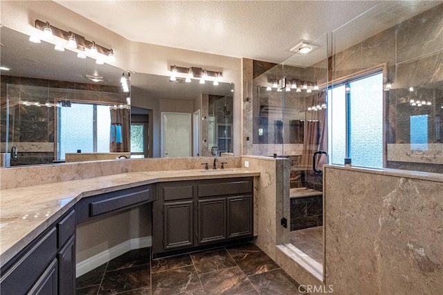 35467 Meadow Park Cir, Wildomar, CA 92595 - bathroom with vanity, marble look tiles, a stall shower, and a textured ceiling