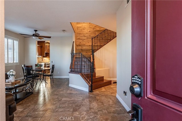 35467 Meadow Park Cir, Wildomar, CA 92595 - foyer entrance featuring a ceiling fan, stairs, and wood walls
