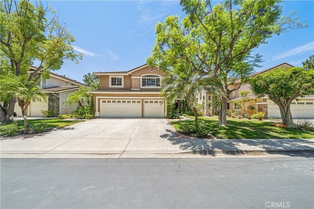 22681 Maplewood, Mission Viejo, CA 92692 - view of front of home with a garage, concrete driveway, stucco siding, and a front yard