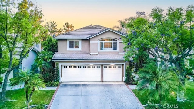 22681 Maplewood, Mission Viejo, CA 92692 - view of front of home with driveway, stucco siding, a garage, and a tiled roof