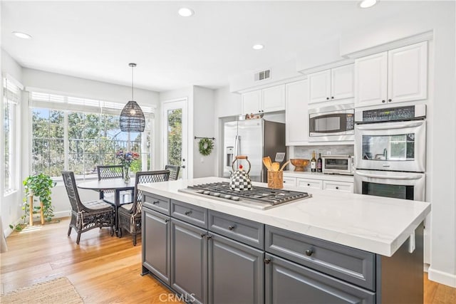 22681 Maplewood, Mission Viejo, CA 92692 - kitchen with stainless steel appliances, gray cabinets, white cabinets, light wood-style flooring, and recessed lighting