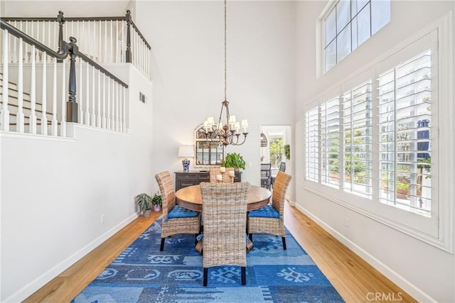 22681 Maplewood, Mission Viejo, CA 92692 - dining area with a chandelier, wood finished floors, and a high ceiling