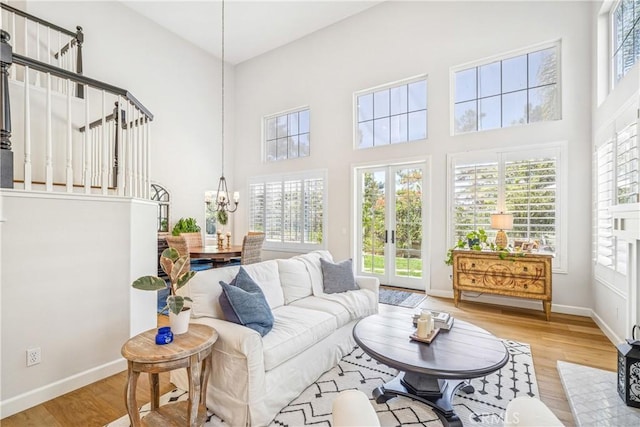 22681 Maplewood, Mission Viejo, CA 92692 - living room with wood finished floors, a high ceiling, and a chandelier