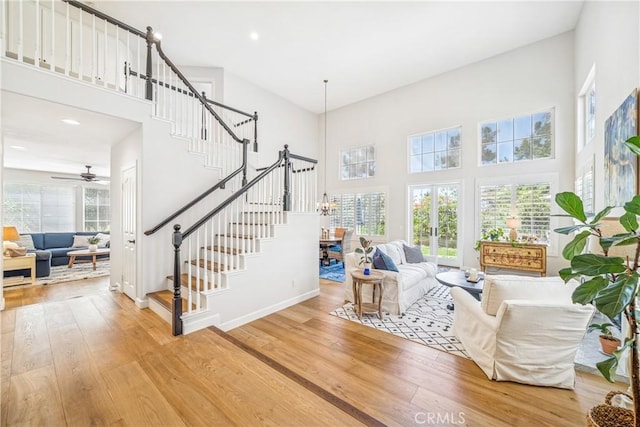 22681 Maplewood, Mission Viejo, CA 92692 - living area featuring a towering ceiling, wood finished floors, stairway, a chandelier, and a ceiling fan