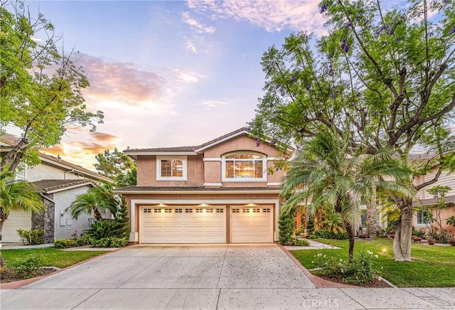 22681 Maplewood, Mission Viejo, CA 92692 - view of front facade with a garage, concrete driveway, stucco siding, and a yard
