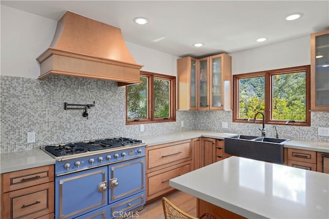 24537 Dry Canyon Cold Creek Rd, Calabasas, CA 91302 - kitchen featuring premium range hood, light countertops, gas cooktop, tasteful backsplash, and glass insert cabinets