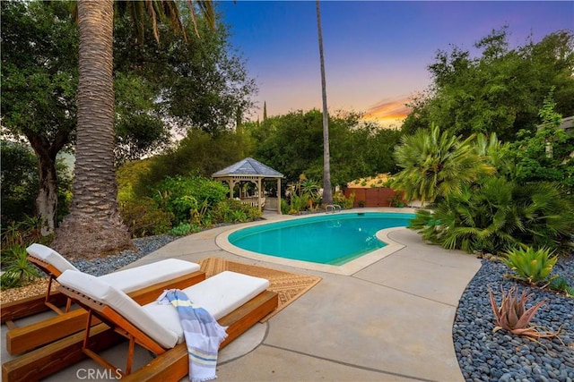 24537 Dry Canyon Cold Creek Rd, Calabasas, CA 91302 - pool at dusk featuring a gazebo, an outdoor pool, and a patio
