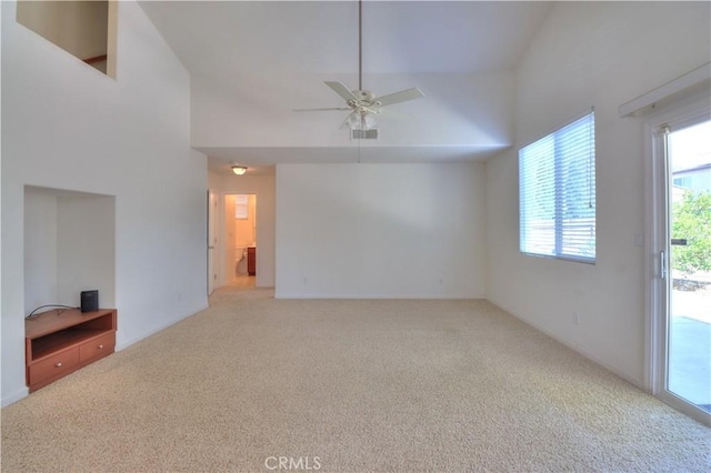 2062 Dunbar Way, Dinuba, CA 93618 - unfurnished living room featuring carpet floors, a ceiling fan, and high vaulted ceiling