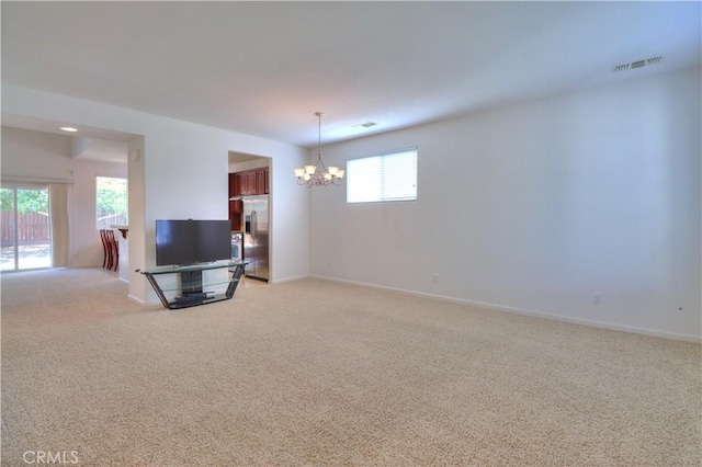 2062 Dunbar Way, Dinuba, CA 93618 - unfurnished living room with light carpet and a chandelier