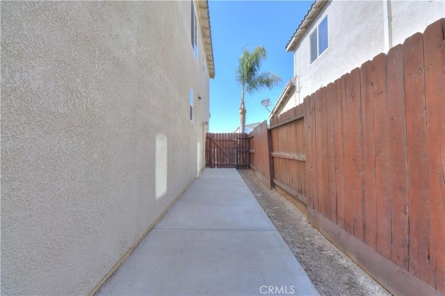 2062 Dunbar Way, Dinuba, CA 93618 - view of side of home with stucco siding and a gate