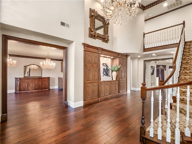 6550 N Blackhawk Ln, Clovis, CA 93619 - foyer featuring a chandelier, a towering ceiling, dark wood-style flooring, ornamental molding, and stairway