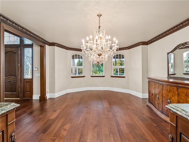 6550 N Blackhawk Ln, Clovis, CA 93619 - unfurnished dining area with healthy amount of natural light, a chandelier, dark wood-style floors, and ornamental molding