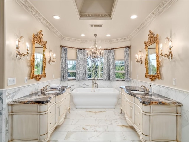 6550 N Blackhawk Ln, Clovis, CA 93619 - full bath with a chandelier, two vanities, wainscoting, a freestanding tub, and recessed lighting