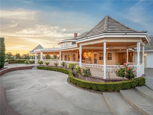 6550 N Blackhawk Ln, Clovis, CA 93619 - rear view of house with a porch and a chimney