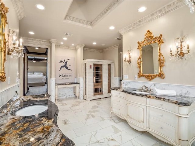 6550 N Blackhawk Ln, Clovis, CA 93619 - ensuite bathroom featuring crown molding, a wainscoted wall, marble look tiles, two vanities, and recessed lighting