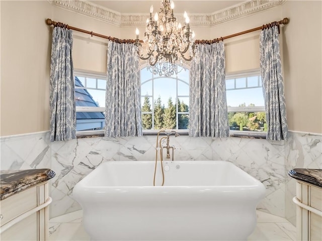 6550 N Blackhawk Ln, Clovis, CA 93619 - full bath featuring tile walls, a chandelier, a freestanding bath, marble tiled flooring, and a wainscoted wall