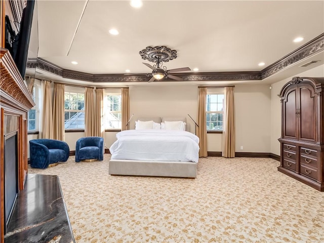 6550 N Blackhawk Ln, Clovis, CA 93619 - bedroom with light colored carpet, crown molding, recessed lighting, multiple windows, and a fireplace
