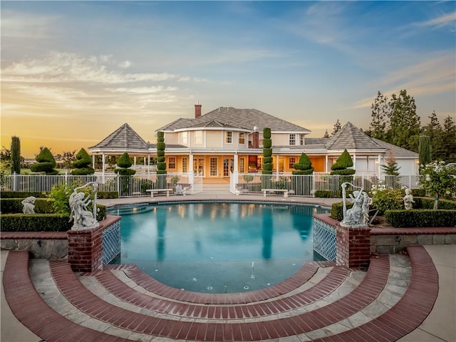 6550 N Blackhawk Ln, Clovis, CA 93619 - pool at dusk featuring a community pool