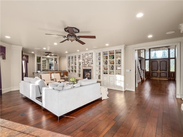 6550 N Blackhawk Ln, Clovis, CA 93619 - living room featuring a ceiling fan, recessed lighting, dark wood-type flooring, stairway, and a stone fireplace