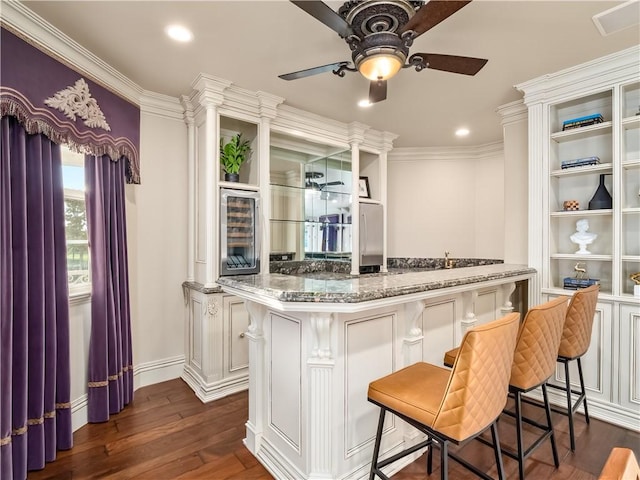 6550 N Blackhawk Ln, Clovis, CA 93619 - kitchen featuring a ceiling fan, beverage cooler, a breakfast bar, dark wood finished floors, and ornamental molding