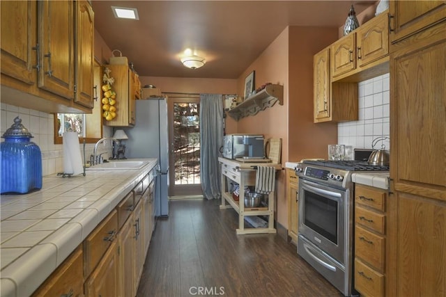 26873 Huron Rd, Lake Arrowhead, CA 92317 - kitchen featuring tile counters, appliances with stainless steel finishes, dark wood-style floors, and decorative backsplash