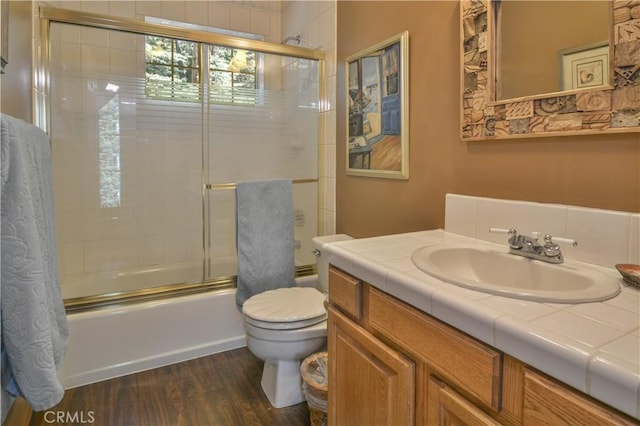 26873 Huron Rd, Lake Arrowhead, CA 92317 - full bath with vanity, bath / shower combo with glass door, and wood finished floors