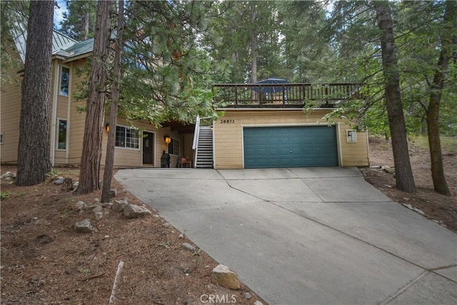26873 Huron Rd, Lake Arrowhead, CA 92317 - obstructed view of property featuring driveway, stairway, and an attached garage