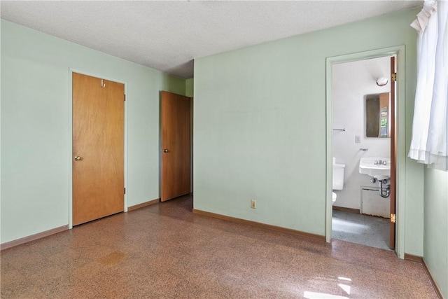 1341 E Monroe, Orange, CA 92867 - unfurnished bedroom featuring ensuite bathroom and a textured ceiling