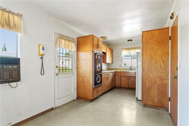 1341 E Monroe, Orange, CA 92867 - kitchen featuring light floors, oven, brown cabinetry, and light countertops
