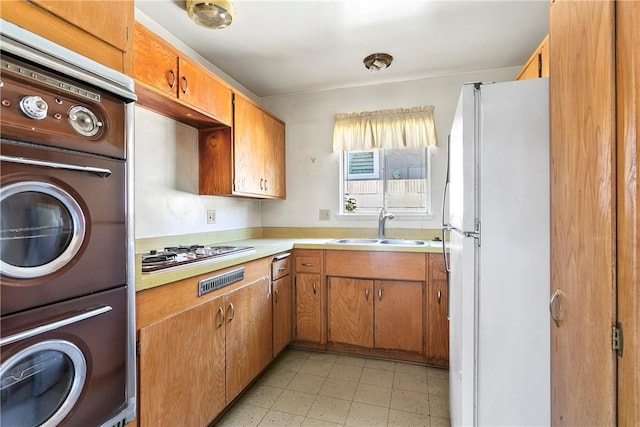 1341 E Monroe, Orange, CA 92867 - kitchen with freestanding refrigerator, stainless steel gas cooktop, oven, and light countertops