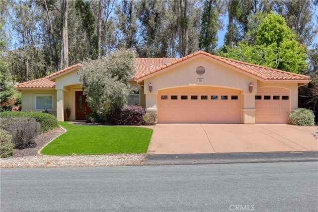 665 Silver Charm Dr, Arroyo Grande, CA 93420 - mediterranean / spanish-style house featuring a garage, stucco siding, driveway, a tile roof, and a front yard