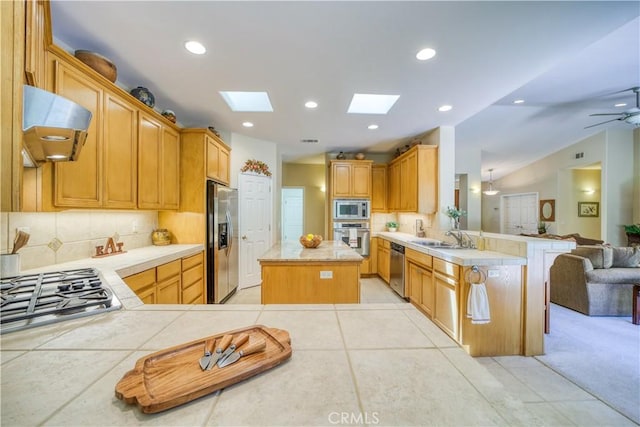 665 Silver Charm Dr, Arroyo Grande, CA 93420 - kitchen featuring appliances with stainless steel finishes, exhaust hood, a peninsula, open floor plan, and decorative backsplash