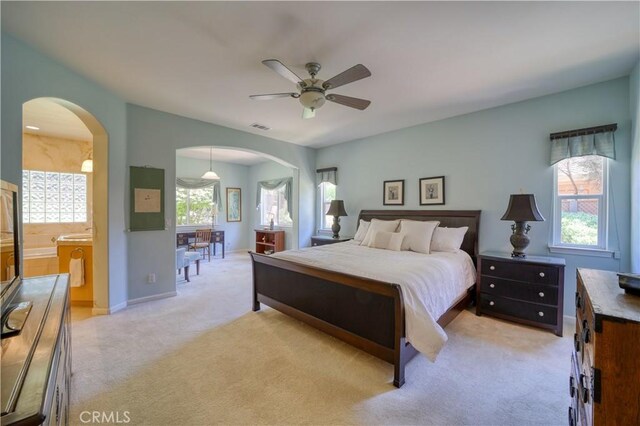 665 Silver Charm Dr, Arroyo Grande, CA 93420 - bedroom featuring arched walkways, light carpet, a ceiling fan, and ensuite bathroom