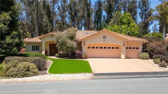 665 Silver Charm Dr, Arroyo Grande, CA 93420 - mediterranean / spanish-style house featuring a garage, a tiled roof, driveway, stucco siding, and a front yard