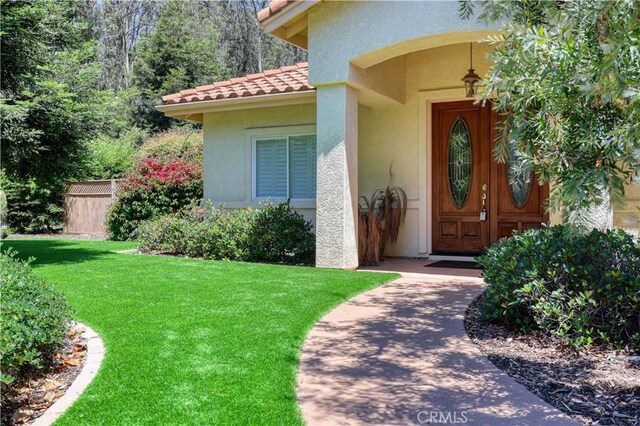 665 Silver Charm Dr, Arroyo Grande, CA 93420 - property entrance with a lawn, stucco siding, and a tiled roof