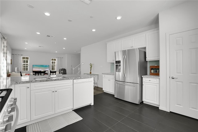 8595 Founders Grove St, Chino, CA 91708 - kitchen featuring stainless steel fridge, white dishwasher, range, white cabinetry, and recessed lighting