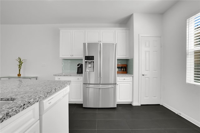8595 Founders Grove St, Chino, CA 91708 - kitchen featuring stainless steel fridge, white dishwasher, dark tile patterned floors, white cabinetry, and decorative backsplash