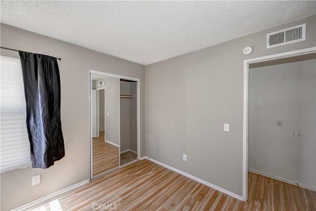 2917 Fairfield Ave, Palmdale, CA 93550 - unfurnished bedroom featuring a closet, wood finished floors, and a textured ceiling