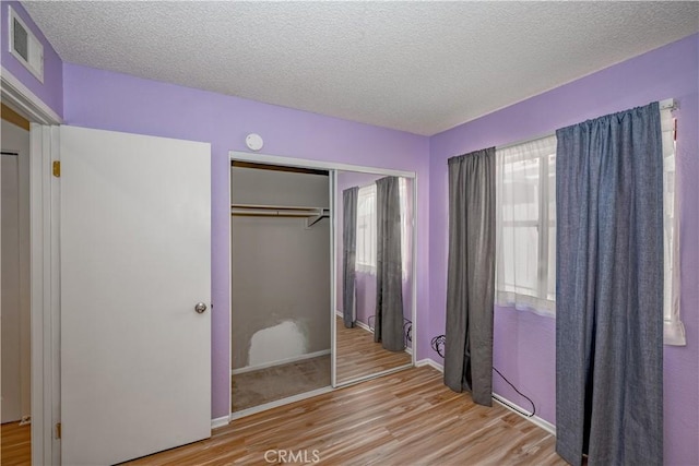 2917 Fairfield Ave, Palmdale, CA 93550 - unfurnished bedroom with wood finished floors, a closet, and a textured ceiling