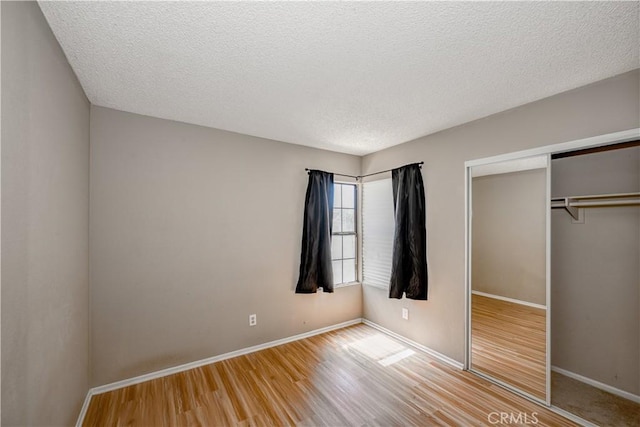 2917 Fairfield Ave, Palmdale, CA 93550 - unfurnished bedroom with wood finished floors, a closet, and a textured ceiling