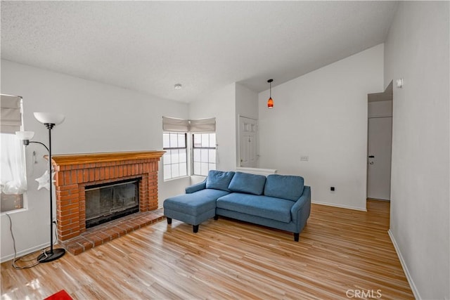 2917 Fairfield Ave, Palmdale, CA 93550 - living area with vaulted ceiling, light wood-style flooring, and a brick fireplace