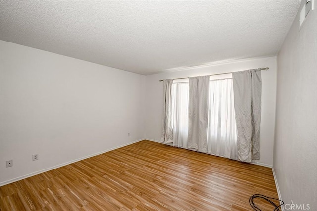 2917 Fairfield Ave, Palmdale, CA 93550 - empty room with light wood-style floors and a textured ceiling