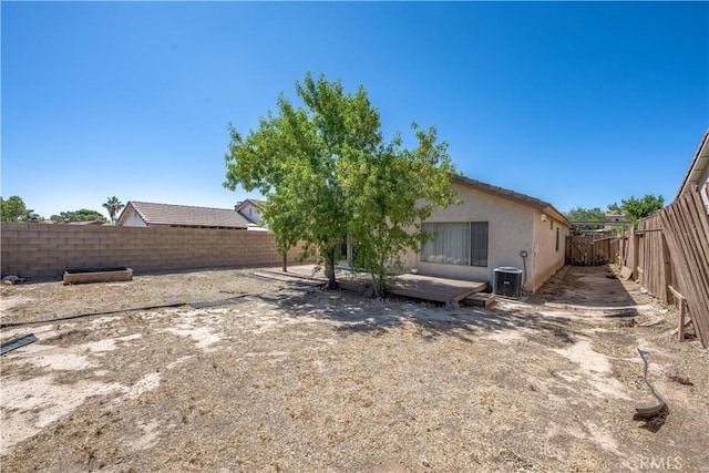 2917 Fairfield Ave, Palmdale, CA 93550 - back of house with a fenced backyard, a deck, and stucco siding