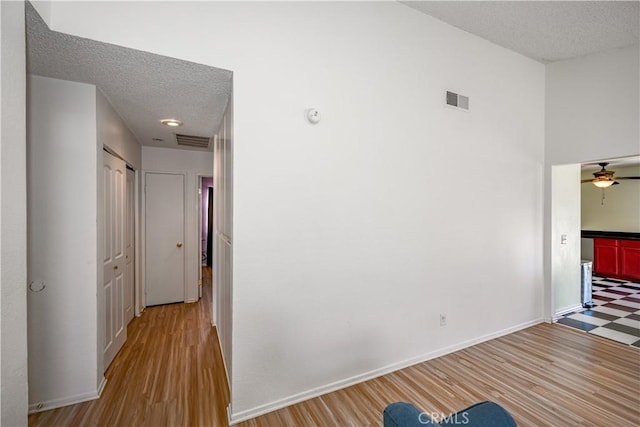 2917 Fairfield Ave, Palmdale, CA 93550 - corridor featuring a textured ceiling and wood finished floors