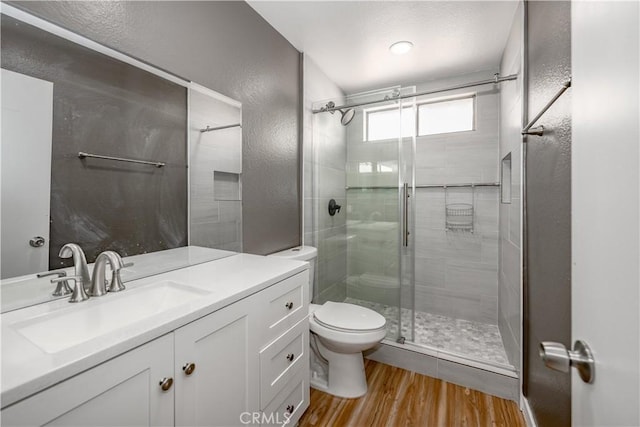 2917 Fairfield Ave, Palmdale, CA 93550 - full bathroom featuring a stall shower, wood finished floors, a textured wall, and vanity