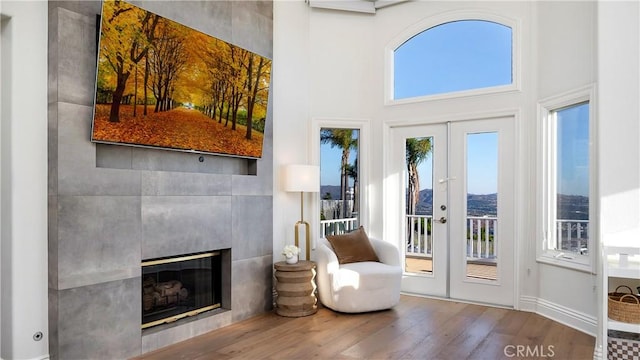 4855 Green Crest Dr, Yorba Linda, CA 92887 - living area featuring wood finished floors, a high ceiling, a fireplace, and french doors